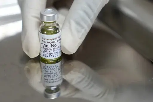 A pharmacist holds a vial of lenacapavir, the new HIV prevention injectable drug, at the Desmond Tutu Health Foundation's Masiphumelele Research Site, in Cape Town, South Africa, Tuesday, July 23, 2024, which was one of the sites for Gilead's lenacapavir drug trial. (AP Photo/Nardus Engelbrecht, File)