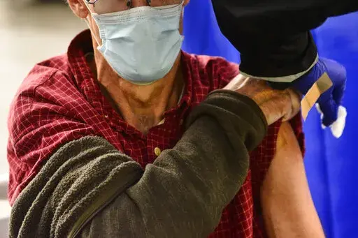A man receives a flu shot in Brattleboro, Vt., on Tuesday, Oct. 26, 2021. This winter's mild flu season has faded to a trickle of cases in much of the U.S., according to data released by the Centers for Disease Control and Prevention in February 2022, but health officials are not ready to call it over. (Kristopher Radder/The Brattleboro Reformer via AP, File)