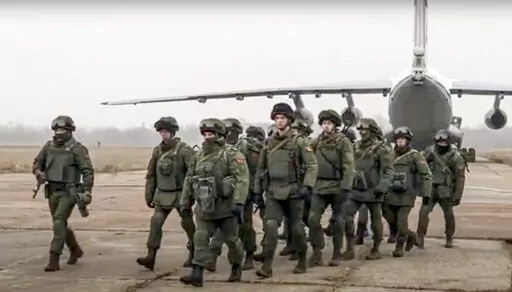 In this handout photo released by Russian Defense Ministry Press Service, Belarusian peacekeepers leave a Russian military plane at an airfield in Kazakhstan, Saturday, Jan. 8, 2022. As Kazakhstan struggles to cope with an increasingly violent uprising this week, it has turned for help to a Russian-led security bloc, the Collective Security Treaty Organization. Thousands of Russian troops have now been dispatched to Kazakhstan to help secure strategic facilities. (Russian Defense Ministry Press 