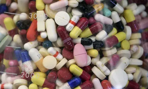 Prescription drugs are seen in a glass flask at a state laboratory in Taylorsville, Utah, on July 6, 2017. (AP Photo/Rick Bowmer, File)
