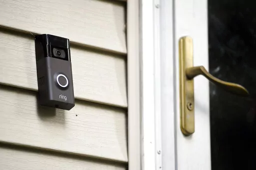A Ring doorbell camera is displayed outside a home in Wolcott, Conn., on July 16, 2019. Two Amazon-owned companies — Ring and Hollywood studio MGM — are teaming up to create a TV show in the mold of “America’s Funniest Home Videos” using viral footage from Ring’s doorbell and smart-home cameras. The half-hour show, called “Ring Nation,” will premier in syndication on Sept. 26, 2022, MGM said. (AP Photo/Jessica Hill, File)