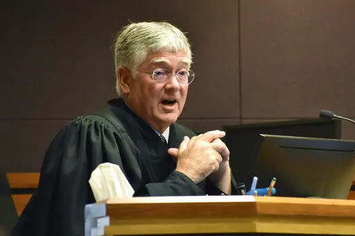 Montana District Judge Michael Moses speaks to attorneys during a court hearing on birth certificate changes for transgender people, on Sept 15, 2022, in Billings, Mont. Moses said in a Monday, Sept. 19, 2022, order that state health officials were being "demonstrably ridiculous" as they repeatedly refused to follow his orders to stop enforcing a state rule that would prevent transgender people from changing the gender on their birth certificate. (AP Photo/Matthew Brown)