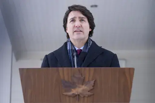 Canadian Prime Minister Justin Trudeau speaks with the media during his first availability after announcing he has COVID-19 at a location in the National Capital Region, Monday, Jan. 31, 2022. Trudeau announced Monday he has tested positive for COVID-19 but is “feeling fine” and will continue to work remotely from home. (Adrian Wyld/The Canadian Press via AP)