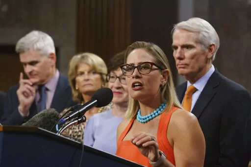 Sen. Kyrsten Sinema, D-Ariz., center, joined from left by, Sen. Bill Cassidy, R-La., Sen. Lisa Murkowski, R-Alaska, Sen. Susan Collins, R-Maine, and Sen. Rob Portman, R-Ohio, speak to reporters just after a vote to start work on a nearly $1 trillion bipartisan infrastructure package, at the Capitol in Washington, July 28, 2021. Sinema received a $1 million surge of campaign cash over the past year from private equity professionals, hedge funds and venture capitalists whose interests she has stau