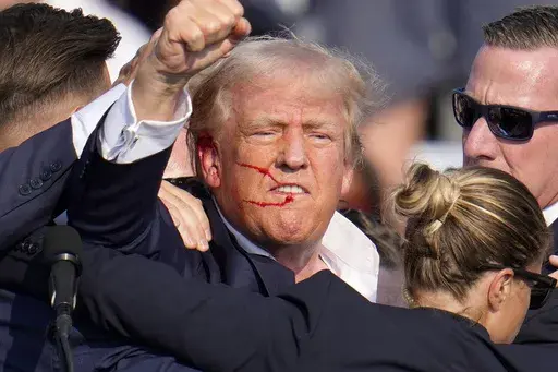 Republican presidential candidate former President Donald Trump reacts following an assassination attempt at a campaign event in Butler, Pa., on Saturday, July 13, 2024. Trump Media surged in the first day of trading, Monday, July 15, following the assassination attempt. (AP Photo/Gene J. Puskar, File)
