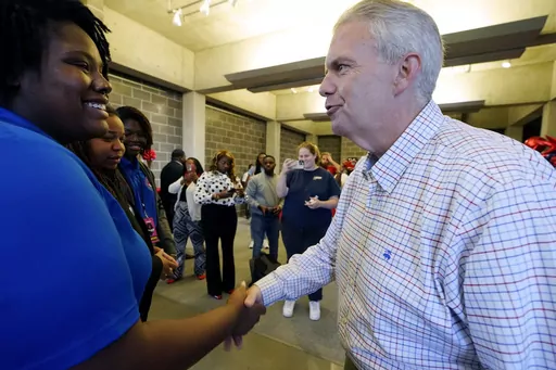 Democratic nominee for governor Brandon Presley, right, shakes hands with a Tougaloo College student, Tuesday, Oct. 24, 2023, during a Jackson, Miss., campaign stop. (AP Photo/Rogelio V. Solis)