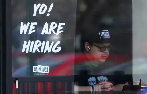 A hiring sign is displayed at a restaurant in Schaumburg, Ill., Friday, April 1, 2022. More Americans applied for unemployment benefits last week, and while layoffs remain low, it's the fifth straight week claims have topped the 230,000 mark. Applications for jobless aid for the week ending July 2 rose to 235,000, up 4,000 from the previous week, the Labor Department reported Thursday, July 7. (AP Photo/Nam Y. Huh, File)