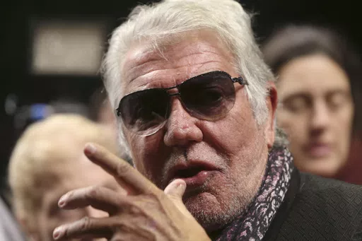 Italian fashion designer Roberto Cavalli talks with journalists prior to the start of the Roberto Cavalli men's Fall-Winter 2014 show, in Milan, Italy on Jan. 14, 2014. Italy’s world-famous fashion designer Roberto Cavalli – known for his flamboyant and glamorous style -- died on Friday, April 12, 2024 aged 83, his company announced in an Instagram post. (AP Photo/Luca Bruno, File)
