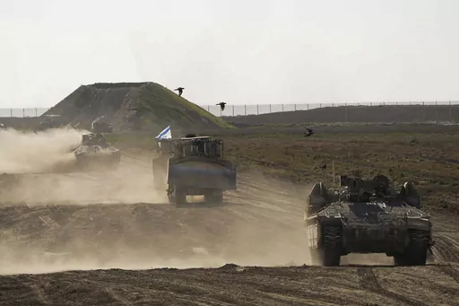Israeli troops move near the Gaza Strip border in southern Israel, Monday, March 4, 2024. The army is battling Palestinian militants across Gaza in the war ignited by Hamas' Oct. 7 attack into Israel. Israel can either try to annihilate Hamas, which would mean almost certain death for the estimated 100 hostages still held in Gaza, or it can cut a deal that would allow the militants to claim a historic victory. Either outcome would be excruciating for Israelis. And either might be seen as accepta