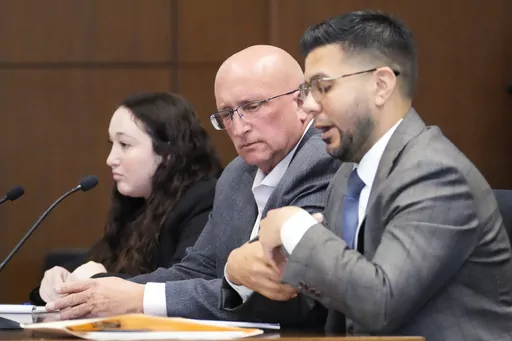 Attorney George Gomez, right, speaks as Attorney Alanna Myerson, left, and Robert E. Crimo Jr., center, listen during an appearance at the Lake County Courthouse, Monday, Aug. 28, 2023, in Waukegan, Ill. Crimo Jr.'s Nov. 6 trial will go head as previously scheduled. (AP Photo/Nam Y. Huh, Pool)