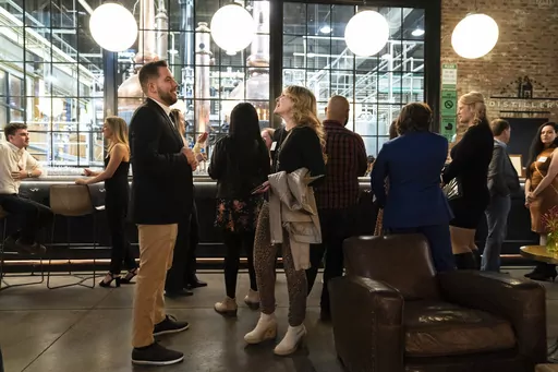 People mingle at a Philadelphia Distilling Daters Mixer Hosted by Date Him Philly, in Philadelphia, Tuesday, Nov. 14, 2023. Some of the most populous urban areas in the United States have an imbalanced sex ratio. Many of the largest counties along the Eastern Seaboard and in the Deep South skew female, while the largest urban counties in the West tilt male, according to data released this fall from the 2022 American Community Survey (AP Photo/Matt Rourke)