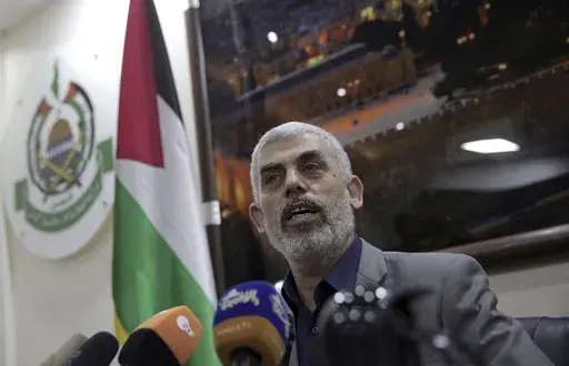 Yahya Sinwar speaks to foreign correspondents in his office in Gaza City on May 10, 2018. (AP Photo/Khalil Hamra, File)