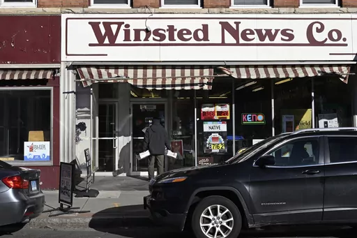 Andy Thibault, Editor and Publisher of The Winsted Citizen, carries bundles of the paper into the Winsted News Co., Friday, Feb. 3, 2023, in Winsted, Conn. American Business Media said Wednesday, Nov. 22 that it has acquired the Winsted Citizen, whose oversight board had decided only two days earlier that it could no longer operate because of financial woes. Terms were not disclosed. (AP Photo/Jessica Hill, File)