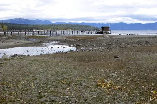 A pier and dock sits above Lake Tahoe's receding shoreline Wednesday, Oct. 20, 2021 at Tahoe City, Calif. There’s no relief in sight for the West’s record-shattering megadrought, which will likely only deepen this spring, the National Oceanic and Atmospheric Administration said in its seasonal outlook Thursday, March 17, 2022. But central and eastern states should be mostly spared from significant flooding. (AP Photo/Scott Sonner, File)