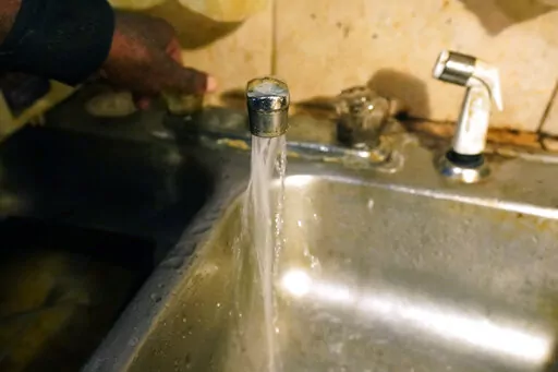 Although the water now flows "just fine" from Charles McCaskill's south Jackson, Miss., home, on Sept . 7, 2022, he says he still won't drink it, noting the current state-issued, boiled-water notice.  A boil-water advisory has been lifted for Mississippi's capital, and the state will stop handing out free bottled water on Saturday. But the crisis isn't over. Water pressure still hasn't been fully restored in Jackson, and some residents say their tap water still comes out looking dirty and smelli