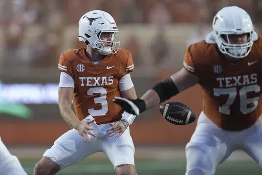 Texas quarterback Quinn Ewers (3) bobbles a snap during the second half of an NCAA college football game against Kentucky in Austin, Texas, Saturday, Nov. 23, 2024. (AP Photo/Eric Gay)