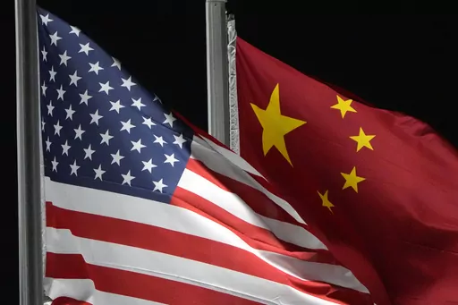 The American and Chinese flags wave at Genting Snow Park ahead of the 2022 Winter Olympics, Feb. 2, 2022, in Zhangjiakou, China. China has been operating a spy base in Cuba since at least 2019, as part of a global effort by Beijing to upgrade its intelligence capabilities. That's according to a Biden administration official who was not authorized to comment publicly and spoke on the condition of anonymity. (AP Photo/Kiichiro Sato, File)