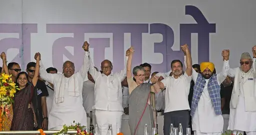 FILE- Opposition leaders raise their hands together during the 'Save Democracy' rally organized by INDIA bloc, a group formed by opposition parties, in New Delhi, India, Sunday, March 31, 2024. India’s bruised and battered opposition, largely written off in the lead-up to the national elections, has now scored a stunning comeback, slowing down the Modi juggernaut and pushing his Bharatiya Janata Party well below the majority mark. (AP Photo/Manish Swarup, file)