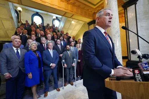 Flanked by most of the Republican members of the House, Speaker Philip Gunn, R-Clinton, presents to reporters the House's position on their state income tax elimination legislation at the Mississippi Capitol in Jackson, Tuesday, March 15, 2022. (AP Photo/Rogelio V. Solis)
