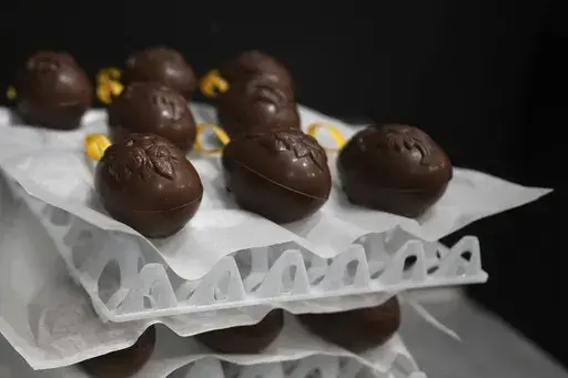 Chocolate eggs dry in the workshop at The Chocolate Line in Bruges, Belgium, Thursday, Feb. 6, 2025. (AP Photo/Virginia Mayo)