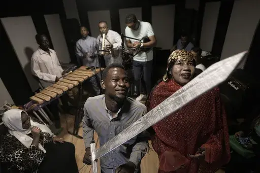 Sudanese Camirata troupe dancers, who lost some of their relatives during the conflict in Sudan, Hoda Othman, right, and Kamal perform Al Saysaed dance from East Sudan during a rehearsal, in Cairo, Egypt, Tuesday, Sept.10, 2024. (AP Photo/Amr Nabil)