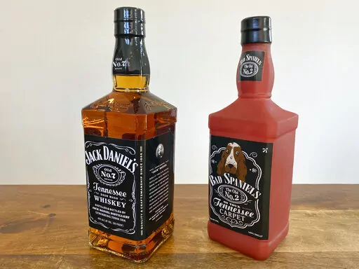 A bottle of Jack Daniel's Tennessee Whiskey is displayed next to a Bad Spaniels dog toy in Arlington, Va., Sunday, Nov. 20, 2022. Jack Daniel's has asked the Supreme Court justices to hear its case against the manufacturer of the toy. (AP Photo/Jessica Gresko)
