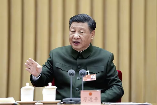 In this photo released by Xinhua News Agency, Chinese President Xi Jinping, also general secretary of the Communist Party of China Central Committee and chairman of the Central Military Commission, attends a plenary meeting of the delegation of the People's Liberation Army (PLA) and the People's Armed Police Force during the first session of the 14th National People's Congress (NPC) in Beijing, on Wednesday, March 8, 2023. Xi has called for "more quickly elevating the armed forces to world-class