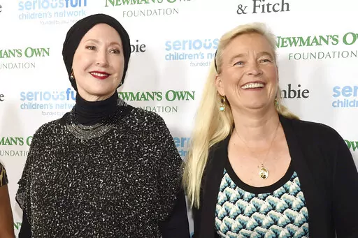 FILE — Susan Newman, left, and Nell Newman arrive at the SeriousFun Children's Network event at the Dolby Theatre, May 14, 2015, in Los Angeles. A new lawsuit filed Tuesday, Aug. 23, 2022, has exposed a deep rift between two of Paul Newman's daughters and the late actor's charitable foundation, over how it gives away some of the millions of dollars it makes off the Newman's Own line of food and drink products. (Photo by Chris Pizzello/Invision/AP, File)