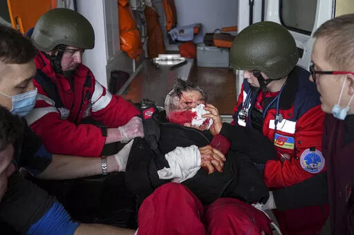 Ambulance paramedics move a civilian wounded in shelling onto a stretcher to a maternity hospital converted into a medical ward in Mariupol, Ukraine, March 2, 2022. A bipartisan group of U.S. lawmakers is calling on the Biden administration to establish field hospitals near Ukraine's border and ramp up medical support for what's expected to be a months-long war of attrition waged by Russia (AP Photo/Evgeniy Maloletka, File)