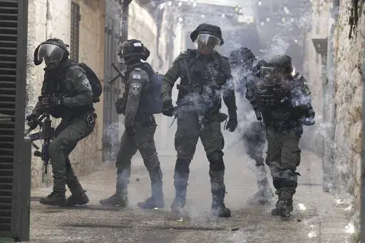 Palestinians shoot fireworks at Israeli police in the Old City of Jerusalem, Sunday, April 17, 2022. Days of violence in Jerusalem and an exchange of fire in Gaza overnight have raised the possibility that Israel and Gaza's Hamas rulers will once again go to war, as they did less than a year ago under similar circumstances. This time around, both Israel and Hamas have powerful incentives to preserve calm — but do not want to be seen as retreating from a Jerusalem holy site at the heart of the 