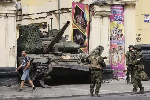 ON HOLD TO GO WITH RUSSIA BELARUS WAGNER STORY FILE Members of the Wagner Group military company guard an area standing in front of a tank in a street in Rostov-on-Don, Russia, Saturday, June 24, 2023. Following an armed rebellion by a mercenary group in Russia, tensions are rising in and around neighboring Belarus, where the exiled leader of the force and some of its fighters are settling in. While authoritarian President Alexander Lukashenko has offered them refuge, that isn't sitting well wit