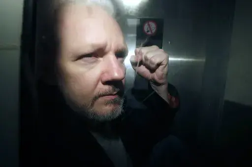 WikiLeaks founder Julian Assange being taken from court, where he appeared on charges of jumping British bail seven years ago, in London, May 1, 2019. (AP Photo/Matt Dunham, File)