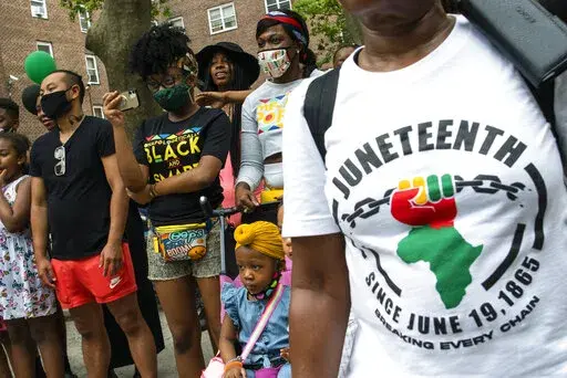 People attend Juneteenth celebrations in the Harlem neighborhood of New York, on June 19, 2021. Recognition of Juneteenth, the effective end of slavery in the U.S., gained traction after the police killing of George Floyd in 2020. But after an initial burst of action, the movement to have it recognized as an official holiday in the states has largely stalled. (AP Photo/Eduardo Munoz Alvarez, File)