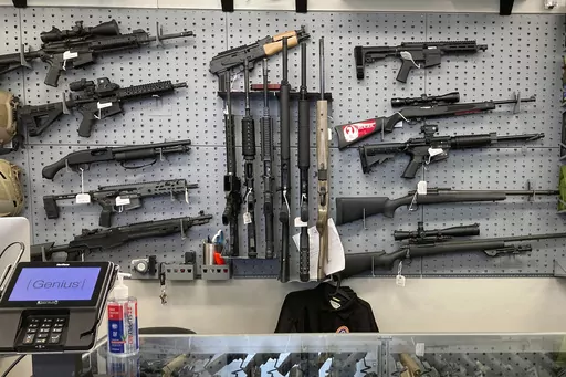 Firearms are displayed at a gun shop in Salem, Ore., Feb. 19, 2021. A federal judge in Portland, Ore., will hear arguments Monday, June 5, 2023, over the constitutionality of one of the nation's strictest gun control laws that was approved by voters last year. The law, which includes a permit-to-purchase provision for gun owners, has been challenged in both federal court and state court and the legal battle over Measure 114 is likely to continue no matter the outcome this week. (AP Photo/Andrew 