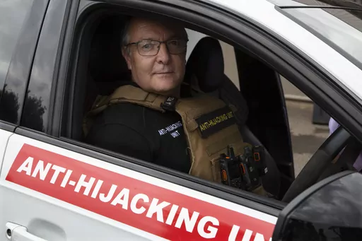 Anton Koen, a former police officer who now runs a private security firm that specializes in tracking and recovering hijacked and stolen vehicles, prepares to go out on patrol east of Johannesburg, South Africa, Tuesday, Nov. 28, 2023. Experts have warned that the South African police are losing the battle against crime and that has led those citizens who can afford it, to turn to a booming private security industry. (AP Photo/Denis Farrell)