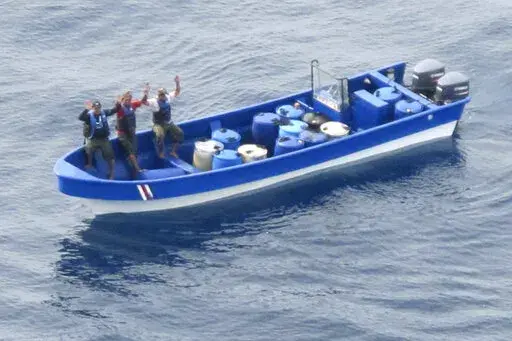 In this photo obtained from U.S. federal court records, Jeffri Dávila-Reyes, third from left, and two others hold their hands in the air as they are intercepted in the Caribbean Sea on Oct. 29, 2015. Dávila-Reyes says he’s still mystified how he ended up serving hard time in a U.S. federal prison. His cocaine bust at sea was closer to his homeland of Costa Rica than the United States, and the few kilos of drugs he was carrying were bound for Jamaica rather than American shores. (U.S. Coast G