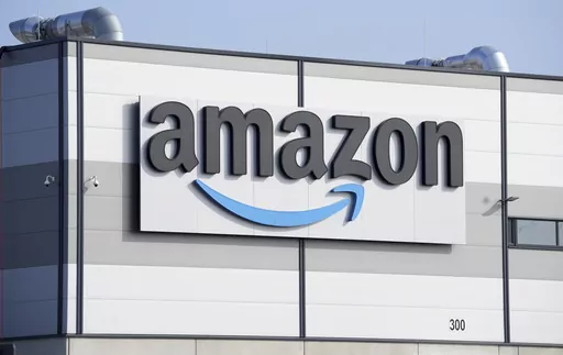 An Amazon company logo marks the facade of a building in Schoenefeld near Berlin, March 18, 2022. The Federal Trade Commission and 17 state attorney generals filed an antitrust lawsuit against Amazon on Tuesday, Sept. 26, 2023, alleging the e-commerce behemoth uses its position in the marketplace to inflate prices on other platforms, overcharge sellers and stifle competition. (AP Photo/Michael Sohn, File)