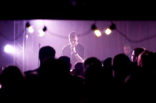 Viacheslav Drofa, known as Otoy, performs during a concert to raise funds for soldiers fighting for Ukraine in Kyiv, Ukraine, Sunday, June 5, 2022. From the battlefronts of Ukraine comes rap music — filled with the anger and indignation of a young generation that, once the fighting is done, will certainly never forget and may never forgive.Ukrainian rapper-turned-volunteer soldier Otoy is putting the war into words and thumping baselines, tapping out lyrics under Russian shelling on his phone,
