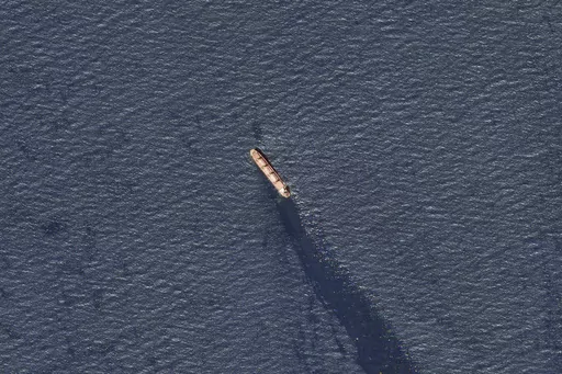 In this satellite image provided by Planet Labs, the Belize-flagged bulk carrier Rubymar is seen in the southern Red Sea near the Bay el-Mandeb Strait leaking oil after an attack by Yemen's Houthi rebels Tuesday, Feb. 20, 2024. Despite a month of U.S.-led airstrikes, Yemen's Iran-backed Houthi rebels remain capable of launching significant attacks. This week, they seriously damaged a ship in a crucial strait and apparently downed an American drone worth tens of millions of dollars. (Planet Labs 