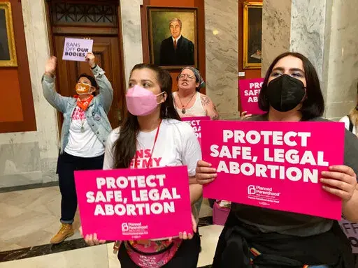FILE -Abortion-rights supporters chant their objections at the Kentucky Capitol on Wednesday, April 13, 2022, in Frankfort, Ky. A federal judge on Thursday May 19, 2022 extended an order blocking key portions of a new Kentucky abortion law that had forced the state's two clinics to temporarily halt abortions. (AP Photo/Bruce Schreiner, File)