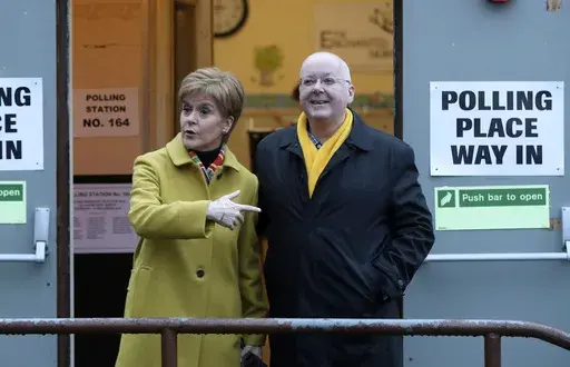 Scottish First Minister Nicola Sturgeon poses for the media with husband Peter Murrell, outside polling station in Glasgow, Scotland, on Dec. 12, 2019. The husband of former Scottish First Minister Nicola Sturgeon has been re-arrested in a probe into the finances of Scotland's pro-independence governing party. Police Scotland said a 59-year-old man had been taken into custody on Thursday, April 18, 2024 and was being questioned by detectives. While police did not name the suspect, the details pr