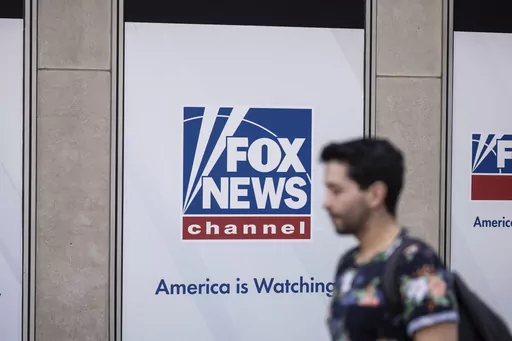 A person walks past the Fox News Headquarters in New York, April 12, 2023. The Delaware judge overseeing Dominion Voting Systems' $1.6 billion defamation lawsuit against Fox News announced late Sunday, April 16, that he was delaying the start of the trial until Tuesday, April 18. He did not cite a reason. The trial, which has drawn international interest, had been scheduled to start Monday morning with jury selection and opening statements. (AP Photo/Yuki Iwamura, File)