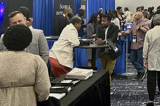 Panelists, recruiters and attendees, network and discuss changes in the industry among other media professionals at the Hilton Chicago, Thursday, August 1, 2024, at the 2024 National Association of Black Journalists convention in Chicago. (AP Photo/Cheyanne Mumphrey)