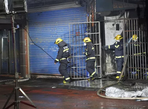 Firefighters work at the site of a building fire in Xinyu City, east China's Jiangxi Province, Wednesday, Jan. 24, 2024. Chinese state media say at least 39 people died and nine others were injured after a fire broke out in southeastern Jiangxi province. State broadcaster CCTV reported that local authorities said that the fire broke out Wednesday afternoon. The building houses an internet cafe in the basement and tutoring centers on upper floors. Local government officials were deployed to the s