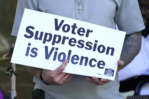 A person previously convicted of a felony felon holds a sign about voter suppression during a Poor People's Campaign assembly in Jackson, Miss., on Monday, April 19, 2021. The demonstrator was among speakers who called for Mississippi to simplify the way it restores voting rights to people convicted of some felonies. On Friday, June 30, 2023, the U.S. Supreme Court said it would not consider a case challenging Mississippi's practice of removing voting rights from people convicted of some crimes.