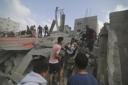 Palestinians look for survivers in buildings destroyed in the Israeli bombardment of the Gaza Strip in Rafah, Sunday, Oct. 22, 2023. (AP Photo/Hatem Ali)