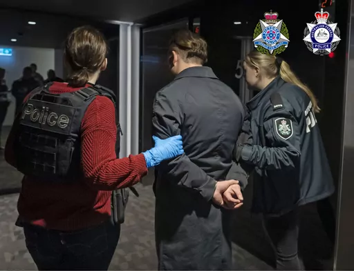 In this photo provided by the Australian Federal Police a man is taken into custody in Melbourne, Wednesday, June 14, 2023. A drug syndicate that tried to smuggle tons of methamphetamine from Canada to Australia and New Zealand by hiding it in shipments of maple syrup and canola oil has been busted, authorities said Thursday, June 15. (Australian Federal Police via AP)