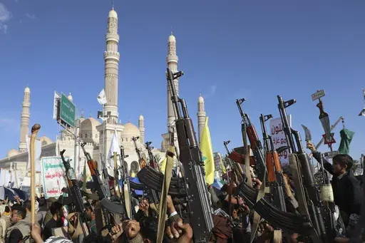Houthi supporters raise their machine guns during an Anti- U.S and Israel rally in Sanaa, Yemen, Friday, Nov. 1, 2024. (AP Photo/Osamah Abdulrahman)