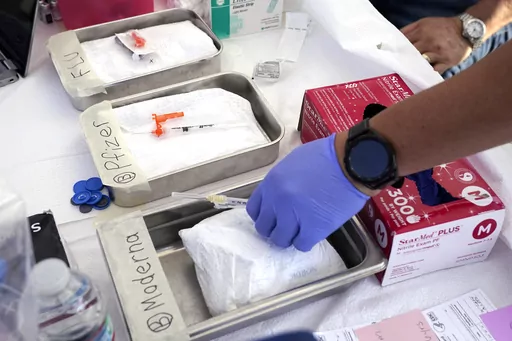 Syringes with vaccines are prepared at the L.A. Care and Blue Shield of California Promise Health Plans' Community Resource Center where they were offering members and the public free flu and COVID-19 vaccines Oct. 28, 2022, in Lynwood, Calif. A new U.S. intelligence report rejects several points raised by those who argue COVID-19 leaked from a Chinese lab. It instead reiterates that American spy agencies remain divided over how the pandemic began. (AP Photo/Mark J. Terrill, File)