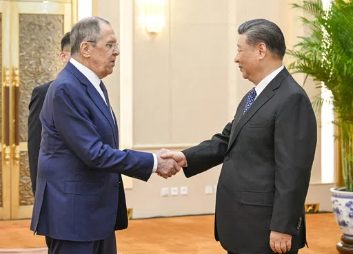 In this photo released by Xinhua News Agency, Russian Foreign Minister Sergey Lavrov, left, and Chinese President Xi Jinping meets at the Great Hall of the People in Beijing on April 9, 2024. China has surged sales to Russia of machine tools, microelectronics and other technology that Moscow in turn is using to produce missiles, tanks, aircraft and other weaponry. That's according to two senior Biden administration officials who discussed the sensitive findings on the condition of anonymity. Rus